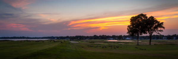 The sun sets in over the harbor in idyllic Southport, CT